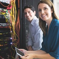 two people working on a computer network