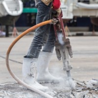 person using a jack hammer