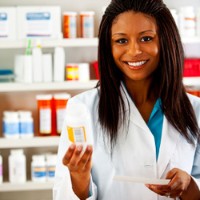 pharmacy technician holding up a medicine bottle