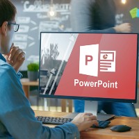 person opening powerpoint on a desktop