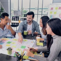 a team sitting at a table working on a project