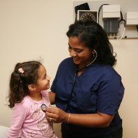 nurse listening to childs heart